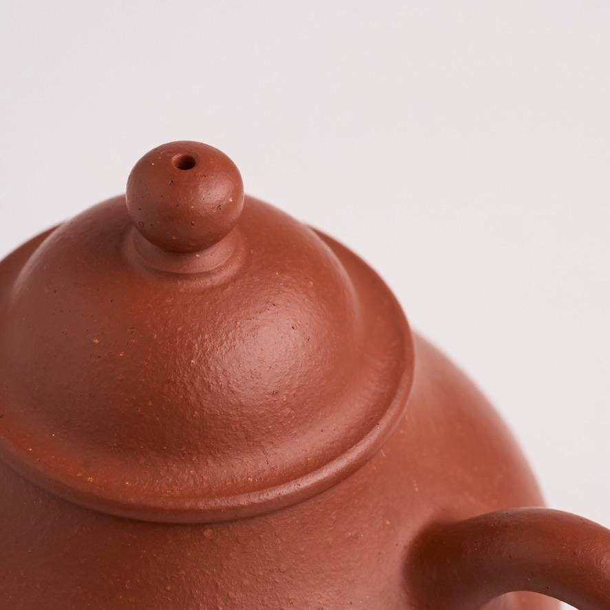A slightly upturned lid edge on a Yixing teapot, one of the hidden details locals look at